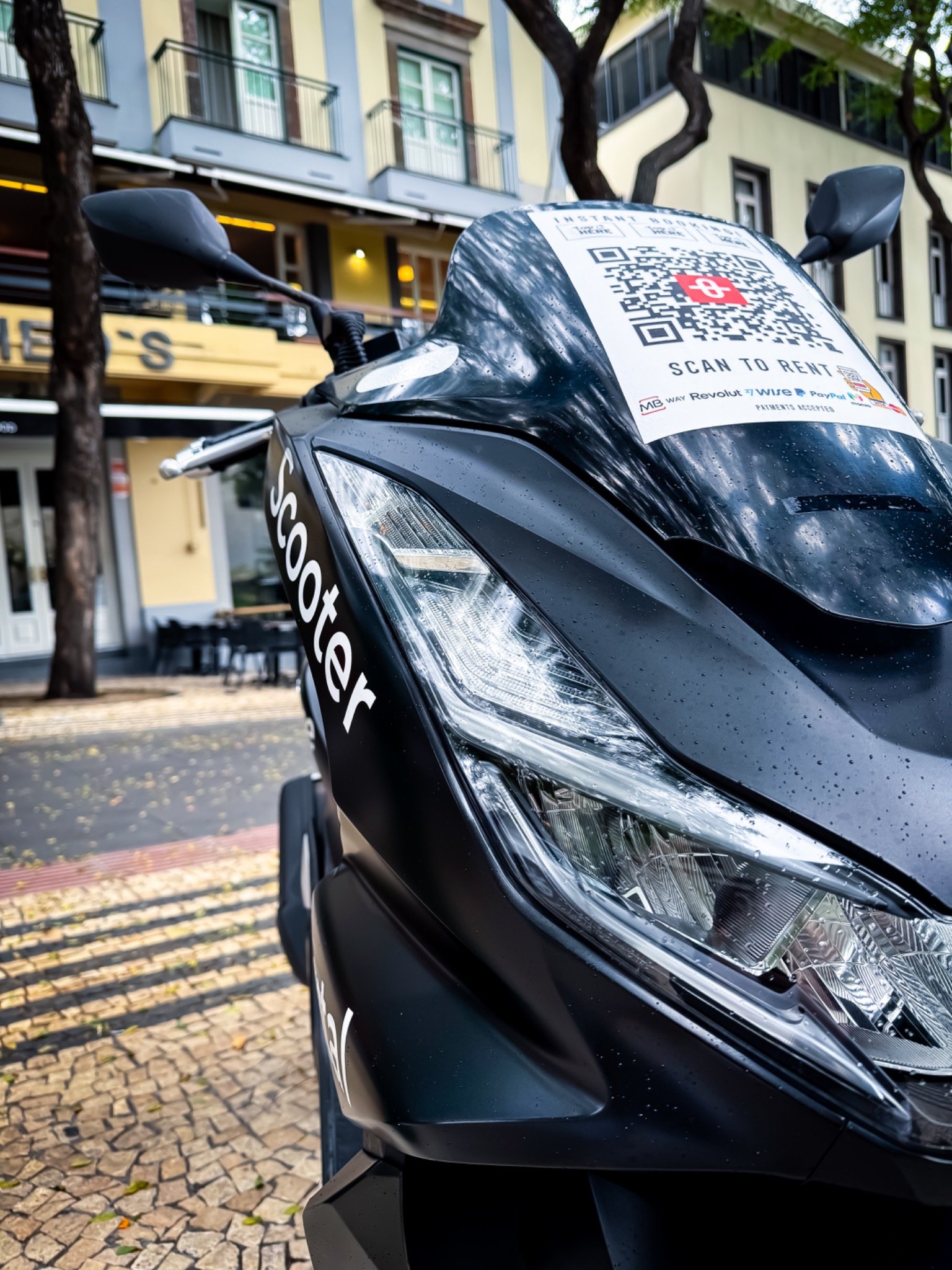 Black Honda rental scooter parked on a street in Funchal